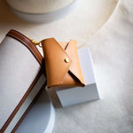 Sidecar ID envelope with premium leather finish and snap closure, designed to securely hold identification and small essentials.v