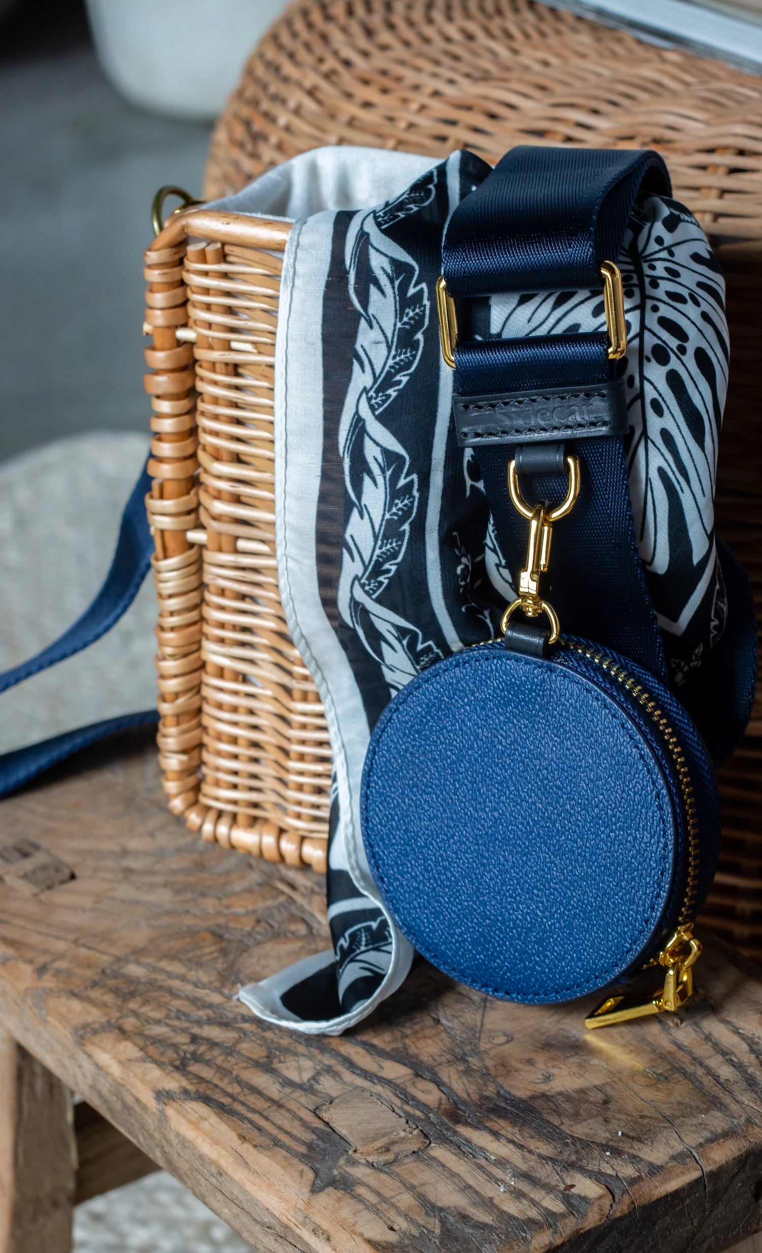 Sidecar indigo blue nylon purse strap, featuring a smooth durable design, gold accents, and adjustable length for bags. Matching indigo blue round coin purse with gold accents. Hands-free, secure carry.