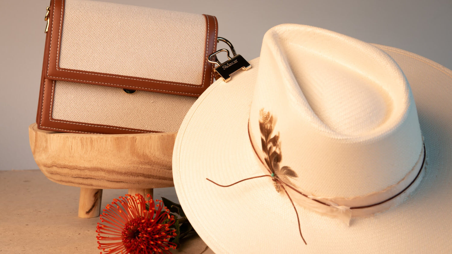 Sidecar Premium 14k Gold Duo Set. Close-up of oval hinge clasp and patented hat-safe tension system. Sidecar Duo Set used on luxury hat with intricate feather.