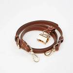 Sidecar The OG 14K gold hat clip with genuine brown leather side strap, white stitching, and adjustable leather strap with 14k hardware. Luxury, hands-free hat carry worn in 4 styles: Crossbody, Backpack, Purse-style, and Waist-wear.