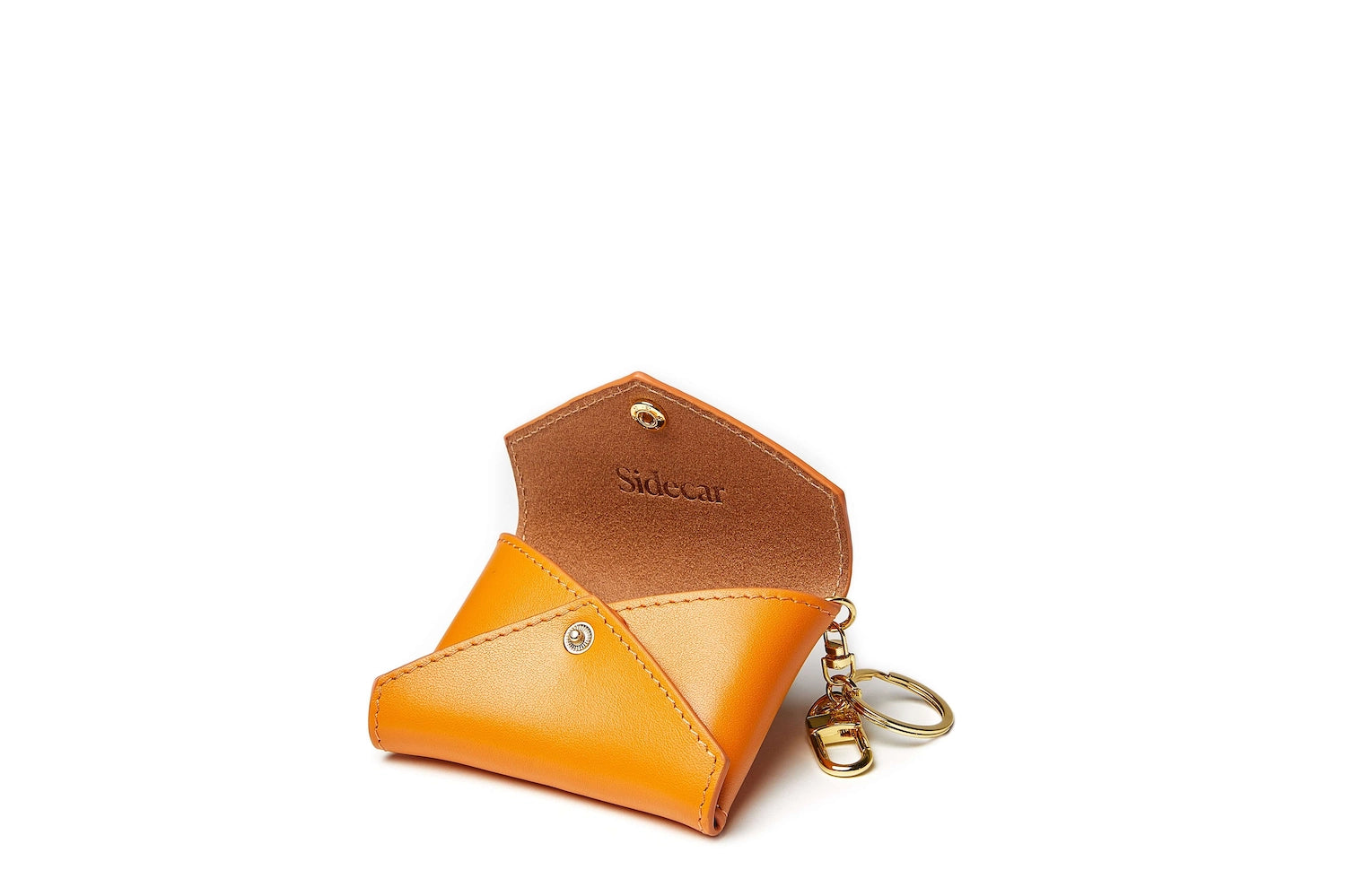 Sidecar carrot brown ID envelope with premium leather finish and snap closure, designed to securely hold identification and small essentials.