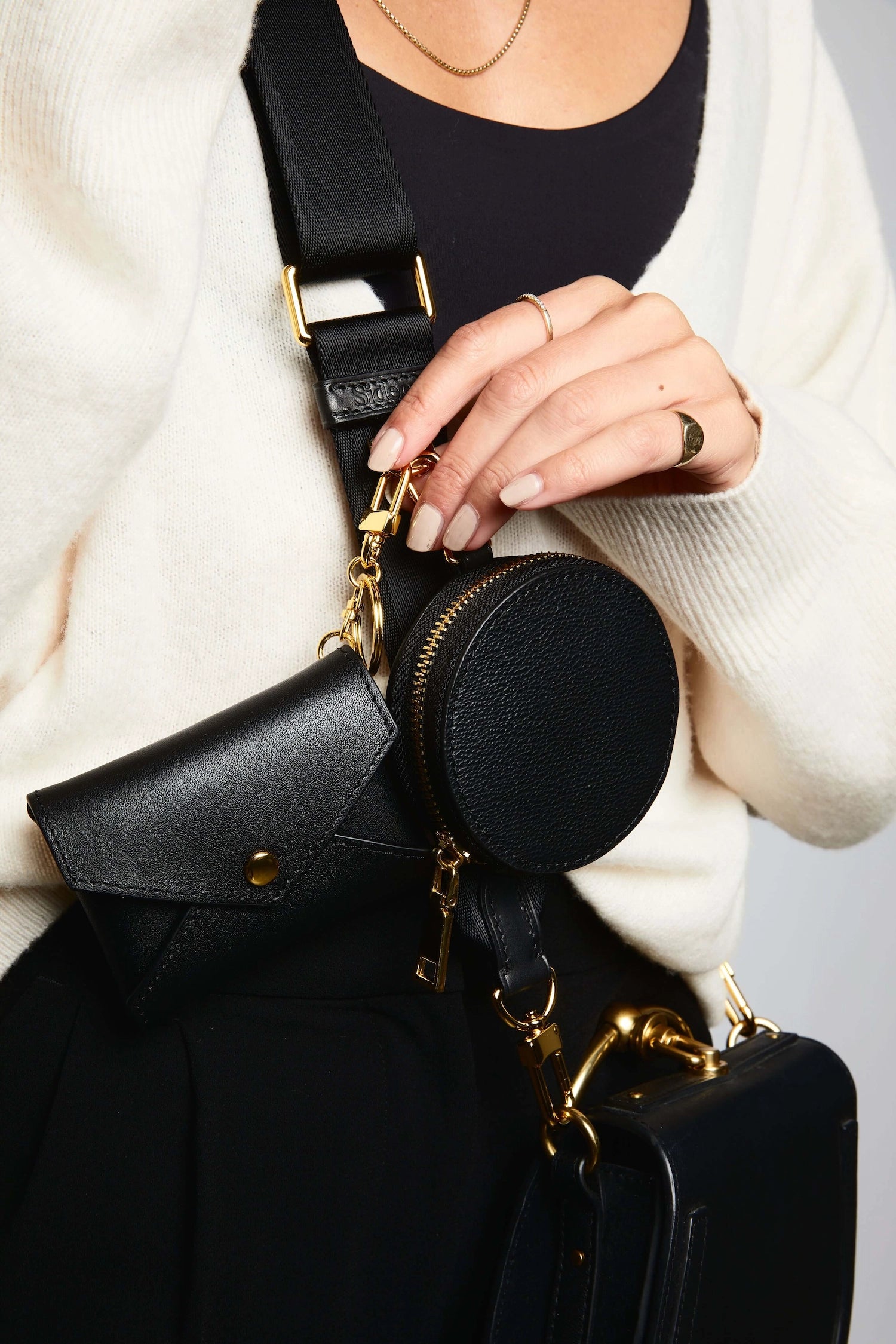 Sidecar Black ID envelope with premium leather finish and snap closure, designed to securely hold identification and small essentials.