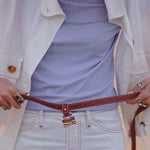 Waist-wear Style shown wearing the Sidecar The OG 14K gold hat clip with genuine brown leather side strap, white stitching, and adjustable leather strap with 14k hardware. Luxury, hands-free hat carry worn in 4 styles: Crossbody, Backpack, Purse-style, and Waist-wear.